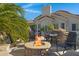Outdoor fire pit area with bar seating, perfect for entertaining around the pool at 8540 E Mcdowell Rd # 10, Mesa, AZ 85207