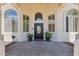Inviting front entrance featuring a decorative door, sidelight windows, and potted plants at 8540 E Mcdowell Rd # 10, Mesa, AZ 85207