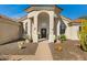 Inviting front entrance with stone walkway, desert landscaping and arched entryway at 8540 E Mcdowell Rd # 10, Mesa, AZ 85207