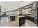 Modern kitchen with dark cabinets, granite countertops, stainless steel appliances, and tile flooring at 8540 E Mcdowell Rd # 10, Mesa, AZ 85207