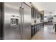 Stainless steel refrigerator complements dark cabinetry and granite countertops in this modern kitchen at 8540 E Mcdowell Rd # 10, Mesa, AZ 85207