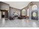 Spacious living room with high ceilings, tile floors, a fireplace, and a front door at 8540 E Mcdowell Rd # 10, Mesa, AZ 85207