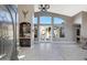 Bright living room with soaring ceilings, tile floors, and access to the outdoors at 8540 E Mcdowell Rd # 10, Mesa, AZ 85207