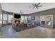 Spacious living room with a fireplace, a large sectional sofa and an exit to the backyard at 8540 E Mcdowell Rd # 10, Mesa, AZ 85207