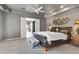 Main bedroom features a large leather bed, access to the ensuite bathroom and a decorative wall decor at 8540 E Mcdowell Rd # 10, Mesa, AZ 85207