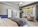 Spacious main bedroom offers plush carpeting, a cozy armchair, and a mounted television at 8540 E Mcdowell Rd # 10, Mesa, AZ 85207