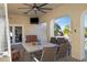 Covered outdoor patio featuring a ceiling fan, an outdoor seating area, and views of lush landscaping at 8540 E Mcdowell Rd # 10, Mesa, AZ 85207