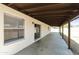 Covered back patio with concrete flooring and view to the expansive backyard at 8571 N 83Rd Dr, Peoria, AZ 85345
