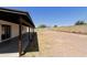 Spacious backyard featuring a covered patio, gravel landscaping, and block wall fencing at 8571 N 83Rd Dr, Peoria, AZ 85345