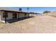 Expansive backyard showcasing a covered patio, gravel area, and block wall, perfect for outdoor enjoyment at 8571 N 83Rd Dr, Peoria, AZ 85345