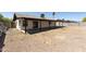 Backyard with a covered patio, gravel ground cover, and block fencing for privacy at 8571 N 83Rd Dr, Peoria, AZ 85345