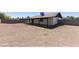 Large gravel backyard with a covered patio area, offering privacy and space at 8571 N 83Rd Dr, Peoria, AZ 85345