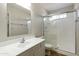 Well-lit bathroom with a walk-in shower and modern vanity at 8571 N 83Rd Dr, Peoria, AZ 85345