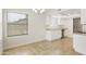 Dining area with chandelier lighting, large window, and adjacent kitchen at 8571 N 83Rd Dr, Peoria, AZ 85345