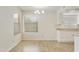 Dining area with chandelier lighting, large window, and adjacent kitchen at 8571 N 83Rd Dr, Peoria, AZ 85345
