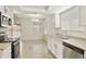 Well-lit kitchen with stainless steel appliances, and ample cabinet space overlooking dining area at 8571 N 83Rd Dr, Peoria, AZ 85345