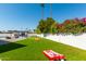 This backyard with a pool, pool house, and a lush lawn creating the perfect outdoor oasis at 8714 E Mackenzie Dr, Scottsdale, AZ 85251