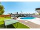 Spacious backyard with pool, patio, ping pong table and putting green perfect for outdoor entertaining at 8714 E Mackenzie Dr, Scottsdale, AZ 85251