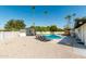 Inviting backyard oasis with a sparkling pool, lounge chairs, and palm trees creating a relaxing atmosphere at 8714 E Mackenzie Dr, Scottsdale, AZ 85251