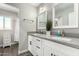 Bright bathroom showcasing dual sinks, granite counters, white cabinets and an additional shower room at 8714 E Mackenzie Dr, Scottsdale, AZ 85251