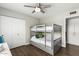 Charming bedroom featuring bunk beds, wood floors, and ample closet space, perfect for a growing Gathering at 8714 E Mackenzie Dr, Scottsdale, AZ 85251