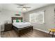 Comfortable bedroom with a large window, wood floors, and a cozy bed for a relaxing retreat at 8714 E Mackenzie Dr, Scottsdale, AZ 85251