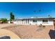 Charming single-story home featuring a two car garage and a desert landscape at 8714 E Mackenzie Dr, Scottsdale, AZ 85251