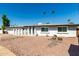 Charming single-story home featuring a well-maintained yard and modern architectural details at 8714 E Mackenzie Dr, Scottsdale, AZ 85251