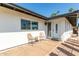 Inviting front porch with seating, offering a cozy and welcoming entrance to the home at 8714 E Mackenzie Dr, Scottsdale, AZ 85251
