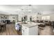 Contemporary kitchen with an island and bar seating, seamlessly flowing into the living and dining spaces at 8714 E Mackenzie Dr, Scottsdale, AZ 85251
