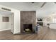 Lovely tiled fireplace with hardwood floors leading to the living and kitchen areas at 8714 E Mackenzie Dr, Scottsdale, AZ 85251