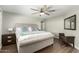 Serene bedroom with a plush upholstered bed, modern furnishings, and hardwood flooring for a relaxing retreat at 8714 E Mackenzie Dr, Scottsdale, AZ 85251