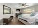 Comfortable main bedroom featuring a large window, dresser, TV, and a well-lit ensuite bathroom at 8714 E Mackenzie Dr, Scottsdale, AZ 85251