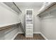 Well-organized walk-in closet with built-in shelving, providing ample storage space for clothes and accessories at 8714 E Mackenzie Dr, Scottsdale, AZ 85251