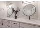 Bathroom features dual sinks, quartz countertops, modern lighting, black hardware, and decor at 8941 E Maple Dr, Scottsdale, AZ 85255