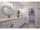 Modern bathroom features dual sinks, quartz countertops, modern lighting, and a walk-in closet at 8941 E Maple Dr, Scottsdale, AZ 85255