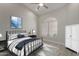Light filled bedroom with vaulted ceiling, picture window, neutral paint, and black metal bed frame at 8941 E Maple Dr, Scottsdale, AZ 85255