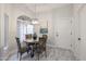 Cozy dining area featuring a round table, four chairs, and a arched window at 8941 E Maple Dr, Scottsdale, AZ 85255