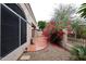 Exterior of home showing an arched window, a small patio, and desert landscaping at 8941 E Maple Dr, Scottsdale, AZ 85255