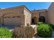 View of single-story beige home with desert landscaping, three-car garage and stylish architecture at 8941 E Maple Dr, Scottsdale, AZ 85255