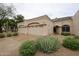 Beige single-story home showcasing a three-car garage, neutral color scheme, and desert landscaping at 8941 E Maple Dr, Scottsdale, AZ 85255