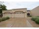 Single-story beige home with three-car garage, desert landscaping and a neutral color palette at 8941 E Maple Dr, Scottsdale, AZ 85255