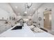 Open-concept kitchen featuring an island, marble fireplace, and views of the living space at 8941 E Maple Dr, Scottsdale, AZ 85255