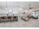 Open floor plan with island seating, white cabinets, and a seamless flow to the living area at 8941 E Maple Dr, Scottsdale, AZ 85255