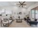 Bright living room featuring a neutral color scheme, vaulted ceiling, and a smooth transition to the kitchen at 8941 E Maple Dr, Scottsdale, AZ 85255