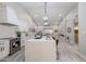 Open concept living and kitchen space featuring quartz counters, white cabinets, and natural lighting at 8941 E Maple Dr, Scottsdale, AZ 85255