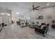 Open-concept living room featuring a high ceiling, kitchen view, neutral color scheme, and recessed lighting at 8941 E Maple Dr, Scottsdale, AZ 85255