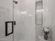 Contemporary shower features marble tiling, black hardware, and built-in niche at 8941 E Maple Dr, Scottsdale, AZ 85255