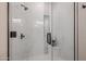 Modern shower with marble tiling, black hardware, and built in niche at 8941 E Maple Dr, Scottsdale, AZ 85255