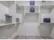 Walk-in closet with ample shelving, modern decor, and wood-look flooring at 8941 E Maple Dr, Scottsdale, AZ 85255